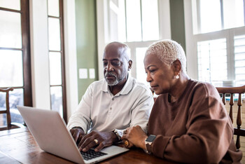 An older couple engages in online couples therapy.